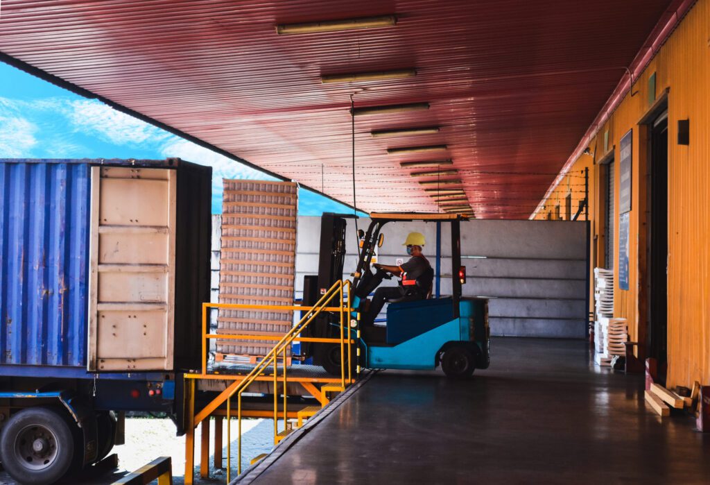 Forklift loading cargo into truck